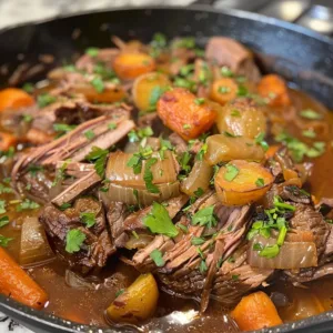 Italian Pot Roast Stracotto served with vegetables and herbs in a rustic dish.