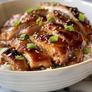 Plate of succulent teriyaki chicken garnished with sesame seeds and green onions