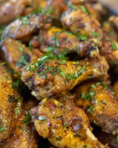 Delicious baked Jamaican jerk chicken wings garnished with herbs and spices