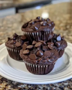 Moist chocolate zucchini muffins with rich chocolate and green zucchini slices