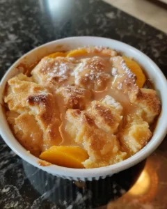 Delicious homemade Southern peach cobbler served in a ceramic dish