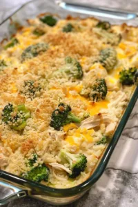 Creamy chicken broccoli rice cheese casserole served in a baking dish