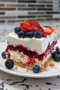 No bake flag cheesecake bars topped with red, white, and blue fruits for a festive dessert