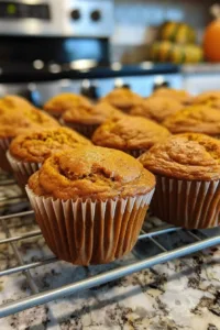 Delicious homemade pumpkin muffins with spices and a golden-brown crust.