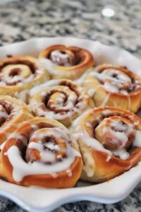 Plate of quick and easy homemade cinnamon rolls with icing.
