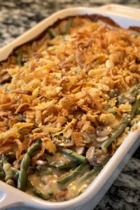 Ultimate green bean casserole topped with crispy onions and served in a baking dish