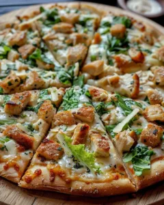 Delicious Chicken Crust Caesar Salad Pizza topped with fresh ingredients