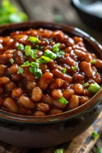 Delicious classic baked beans served in a bowl garnished with herbs.