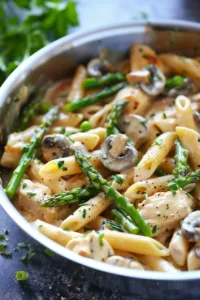 Creamy Mushroom Asparagus Chicken Penne dish served in a bowl