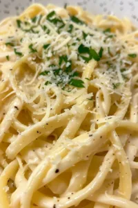 Creamy homemade Alfredo sauce served over fettuccine pasta