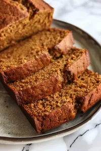 Homemade pumpkin bread loaf displayed on a wooden table