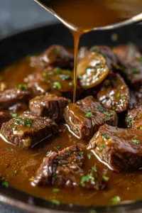 Tender round steak cooked in rich homemade gravy for a delicious meal.