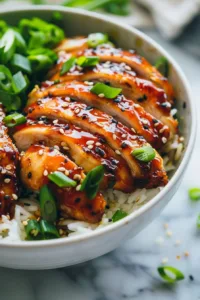 Delicious sticky chicken rice bowls topped with vibrant vegetables and sauce